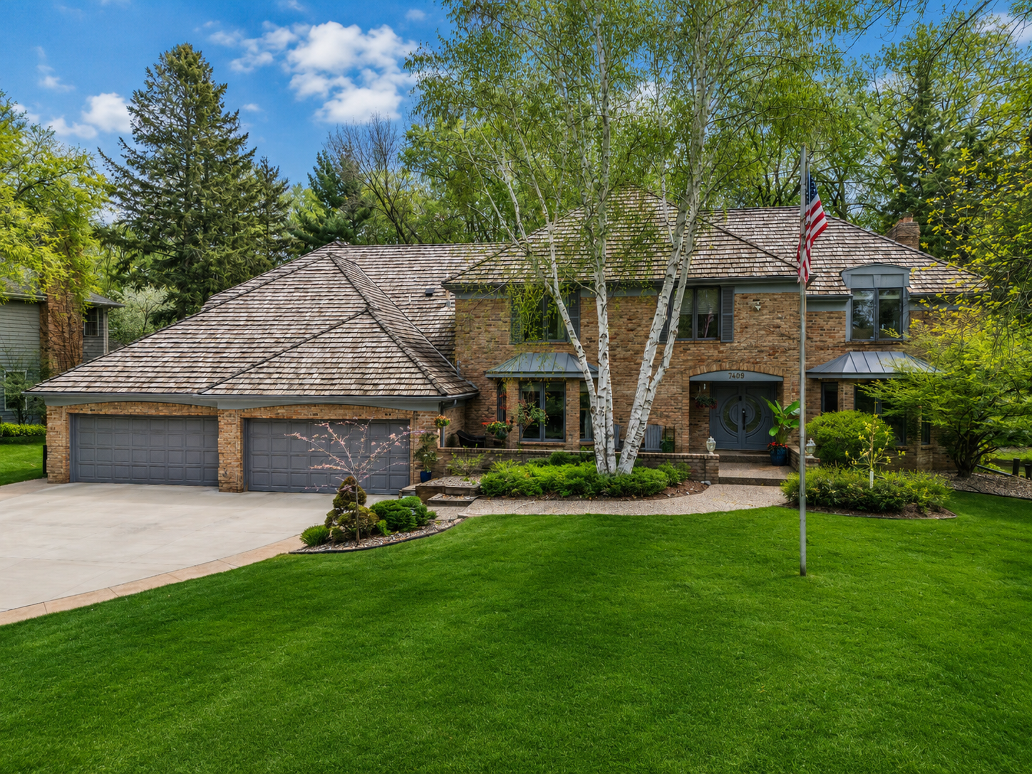 Light for Art — Front Elevation with Three-Car Garage and Cedar Shake Roof