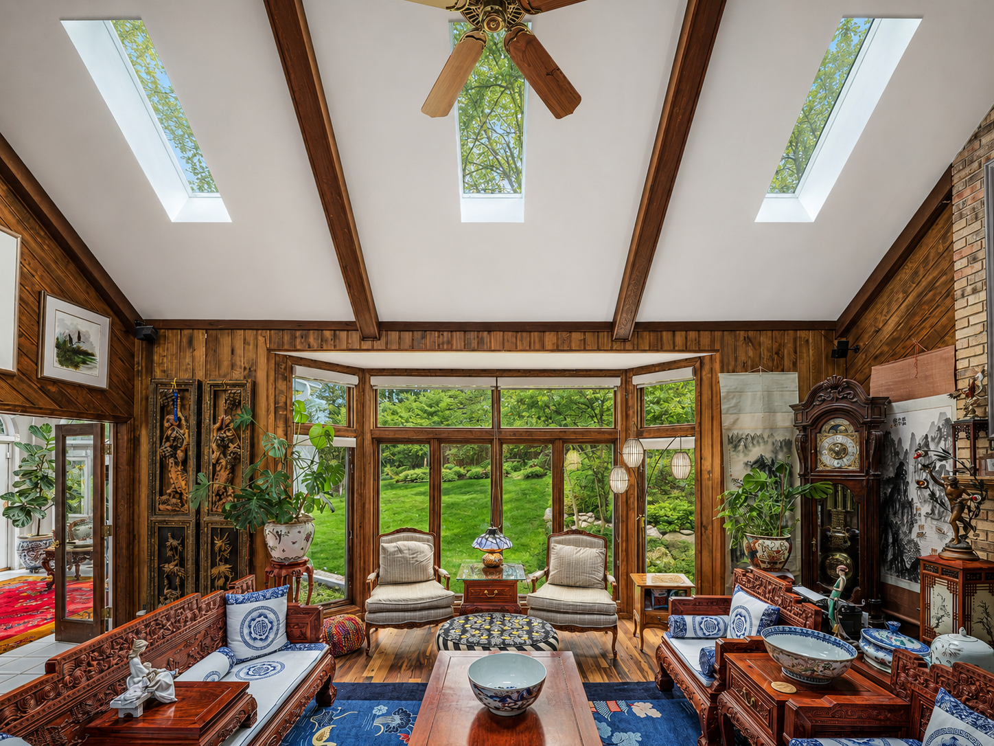 Light for Art — Wide Angle View of Sunroom with Rosewood Furniture and Skylights